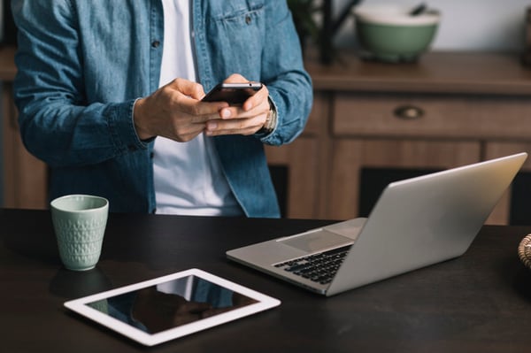 mid-section-young-man-using-smartphone-with-laptop-digital-tablet-coffee-mug-kitchen-counter_23-2147936949 (1)